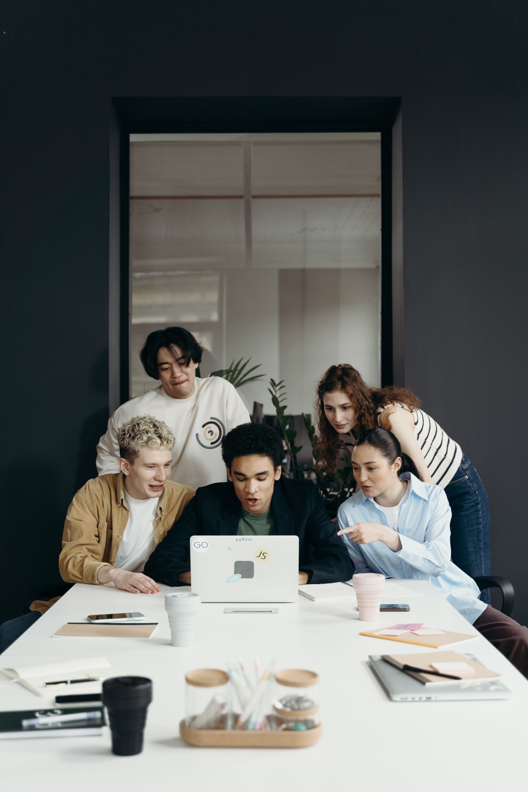 A small crew huddled around one laptop